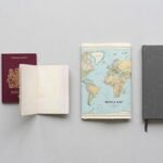 Passport, map and document folders laid out while planning government scholarships 2026 applications